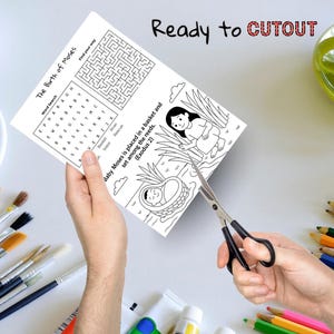 May include: An activity sheet with the title "The Birth of Moses" featuring a word search, maze, and illustration of Moses in a basket. The text "Ready to CUTOUT" is at the top. Scissors are cutting the sheet.