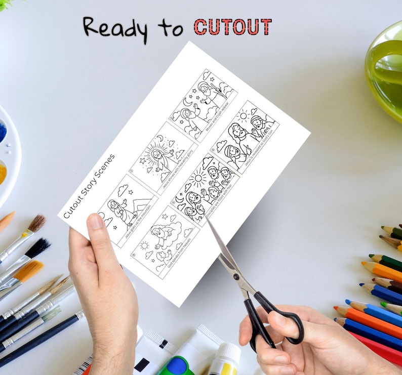 May include: A white sheet of paper with black line drawings of biblical scenes is being cut with scissors. The text "Cutout Story Scenes" and "Ready to CUTOUT" are printed on the paper. The image includes paintbrushes, paint tubes, and colored pencils.