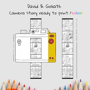 May include: A white and yellow camera illustration with the text "David & Goliath" and "Camera story ready to print / colour." The camera includes a film strip with illustrations. The words "Includes Camera" and "Includes Film Story" are also present.
