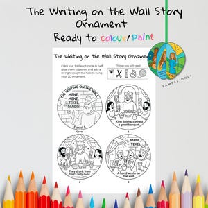 May include: A coloring craft kit featuring a Bible story theme. The kit includes a printable ornament with illustrations from Daniel 5, ready to be colored and assembled. The text "The Writing on the Wall Story Ornament" is displayed at the top.