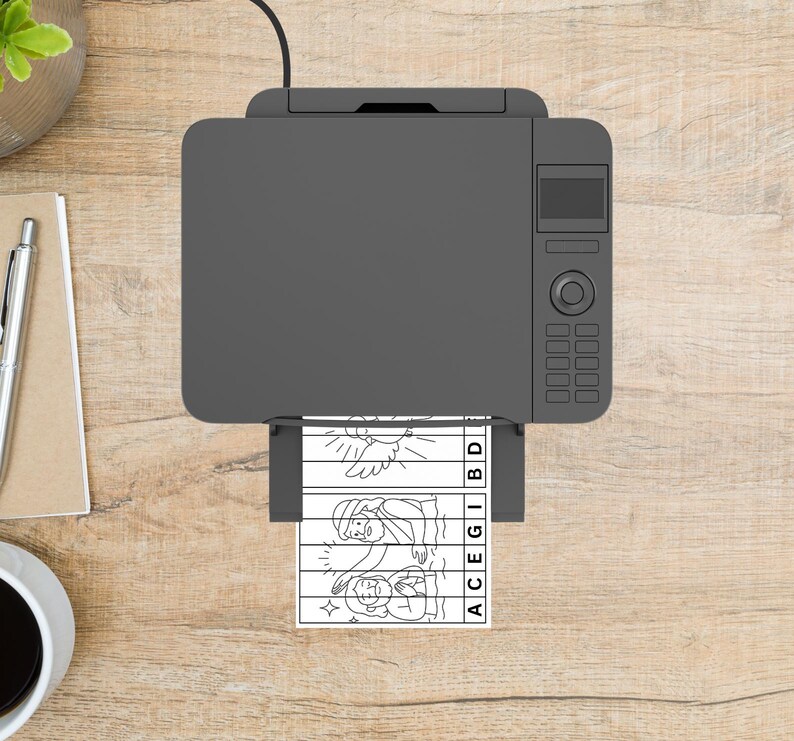 May include: A gray printer is printing a black and white image of a religious scene. The image is a puzzle with the letters ACEGIBD printed on the side. The printer is on a wooden surface.
