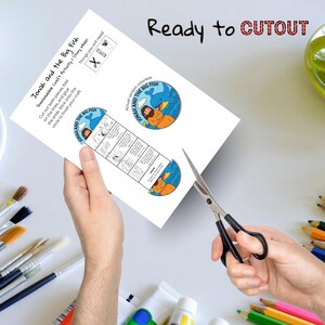 May include: A printable craft activity sheet titled "Jonah and the Big Fish." The sheet includes a story wheel and instructions. The words "Ready to CUTOUT" are printed at the top. A pair of scissors is cutting the paper.