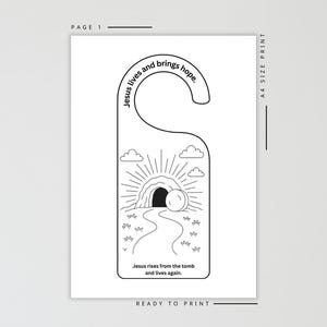 Pode incluir: Cabide de porta a preto e branco com tema religioso. O design apresenta uma ilustra&ccedil;&atilde;o de um t&uacute;mulo com um caminho que conduz a ele, raios de sol, nuvens e o texto "Jesus vive e traz esperan&ccedil;a" e "Jesus ressuscita do t&uacute;mulo e vive de novo."