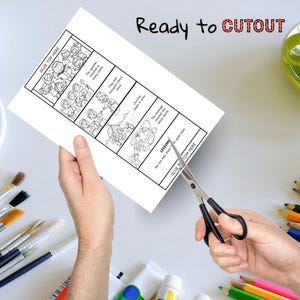 Puede incluir: Una tira c&oacute;mica en blanco y negro con texto, sostenida por manos, que se corta con tijeras. El texto incluye "Ready to CUTOUT" y "GLUE TOP HERE". La tira c&oacute;mica representa escenas con personas y bocadillos de texto.