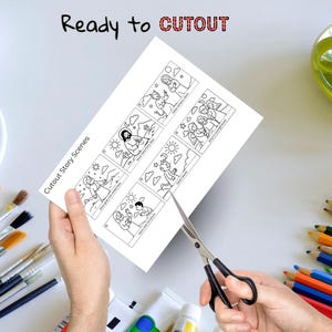 Puede incluir: Una hoja de papel blanca con ilustraciones en blanco y negro de escenas b&iacute;blicas se corta con tijeras. El texto "Ready to CUTOUT" y "Cutout Story Scenes" es visible. Pinceles, tubos de pintura y l&aacute;pices de colores est&aacute;n en el fondo.