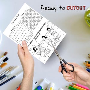May include: A black and white activity sheet with the text "Cain and Abel" and "Ready to CUTOUT". The sheet includes a word search, a maze, and illustrations of biblical figures. Scissors are cutting the sheet.