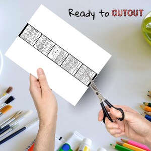 Puede incluir: Una hoja de papel blanca con una tira ilustrada en blanco y negro est&aacute; siendo cortada con tijeras. La tira contiene m&uacute;ltiples paneles con dibujos de personas. El texto "Ready to CUTOUT" est&aacute; escrito en la parte superior.