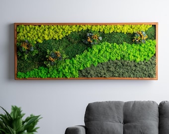 May include: A rectangular wall art piece featuring a vibrant arrangement of preserved moss in varying shades of green and yellow. The moss is set within a natural wood frame, creating a textured, natural aesthetic. Small yellow floral accents are interspersed throughout the design.
