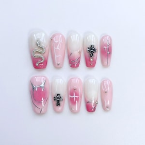 May include: A white ceramic mug with a black handle and the text "But First, Coffee" in a black, bold font. The mug is on a white surface.