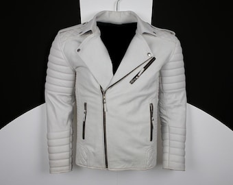 May include: A white leather jacket with a quilted design on the shoulders and sleeves. The jacket features a diagonal zipper closure and multiple pockets. It is hanging on a metal hanger against a black and white background.