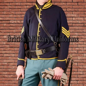 May include: A navy blue military jacket with yellow trim and chevrons, paired with light blue pants. The jacket has gold buttons and a black leather strap. The image includes the text "British Military Uniforms".