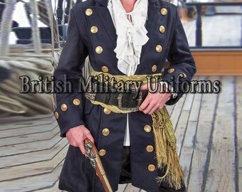 May include: A dark navy blue long coat featuring two rows of gold-toned buttons, worn over a white ruffled shirt. A wide black belt with a large buckle is cinched at the waist, accented by a gold-toned fringed sash. A flintlock pistol is held in hand.