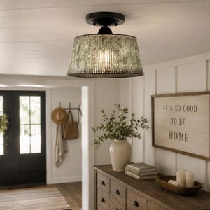 May include: A semi-flush mount ceiling light fixture featuring a cylindrical, corrugated metal shade with a distressed, weathered finish and a black circular canopy, providing downward illumination in a room.