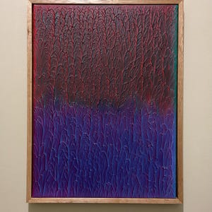May include: Abstract artwork in a wooden frame, featuring a textured surface. The colours transition from deep red to purple. The texture gives a unique visual effect. The frame is made of natural wood.