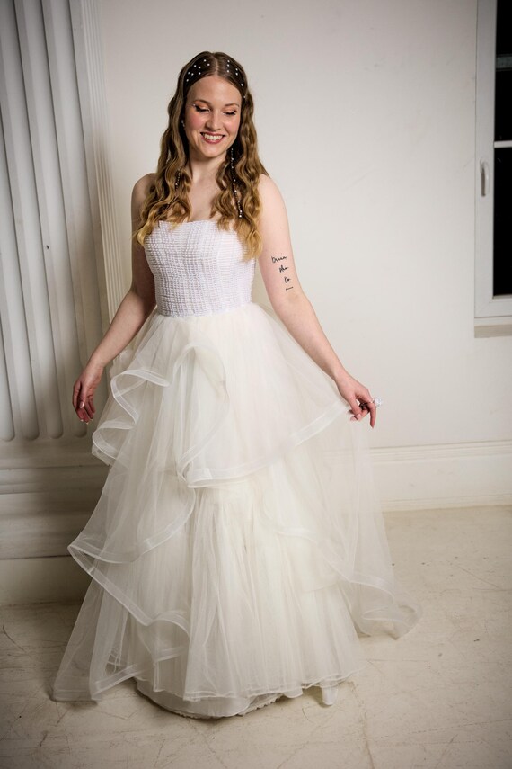 pearl corset dress Usher Strapless Mini Wedding FIORE Strapless%20Pearl%20Sequin%20Lace%20Corset%20Maxi%20Dress%20White%0D%0ADESIGN%3A%0D%0A%0D%0AColor%3A%20White%0D%0AStrapless%20design%0D%0ASleeveless%0D%0ABustier%20detail%0D%0ALace%20insert%0D%0AFloral%20detail%0D%0ASequined%0D%0ADraped%20design%0D%0AEmbellished%20with%20pearls%0D%0AConcealed%20zipper%20at%20back%0D%0AGentle%20Dry%20Clean%20Only%0D%0ALength%3A%20Maxi%0D%0A%0D%0AMATERIAL%3A%0D%0A%0D%0APolyester%20%2B%20Cotton%0D%0AHigh%20quality%20durable%20fabric Tiered Bridal Gown with Beaded
