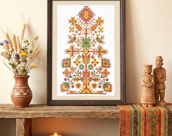 May include: A framed cross-stitch artwork featuring a colorful tree design with geometric patterns in shades of orange, yellow, green, and brown. The artwork is displayed on a rustic wooden shelf, alongside a vase of dried flowers and decorative wooden figurines.