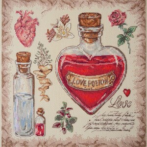 May include: Cross-stitch design featuring a heart-shaped bottle labeled "LOVE POTION" filled with red liquid. Other elements include a human heart, rose, vanilla flowers, and smaller bottles. The background is a beige fabric.