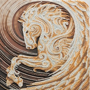 May include: A white and gold beaded horse with wings, created with a swirling pattern. The horse is depicted in a dynamic pose, with its head turned to the side and its wings spread out.