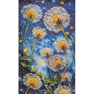 May include: A close-up of a beaded artwork depicting a cluster of white and yellow dandelions against a blue background. The dandelions are made of small beads, creating a textured and realistic effect.