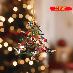 May include: A 2D flat Christmas tree ornament shaped like a tree, adorned with colorful birds. The birds are in various colors, including red, green, blue, and yellow. A gold star hangs at the top, and the text "2D FLAT" is in a red banner.