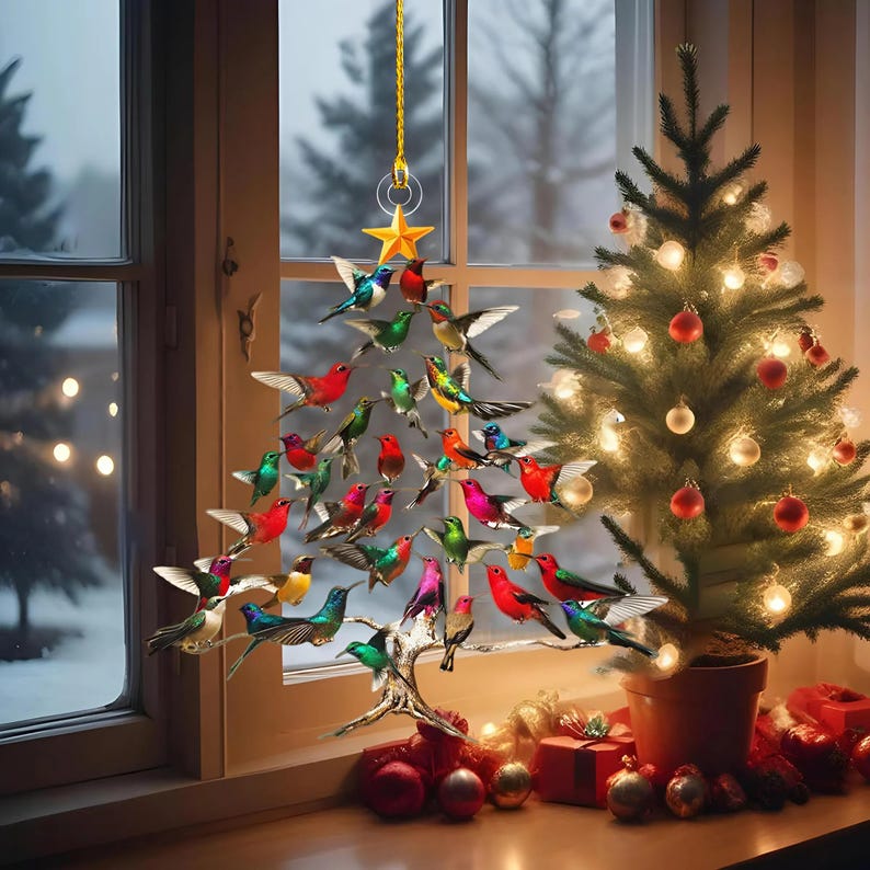 May include: A Christmas tree decoration shaped like a tree, made of colorful hummingbird figurines. The birds are in various colors, including red, green, blue, and pink. A small Christmas tree with lights and ornaments is next to the hummingbird tree.