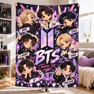 May include: A rectangular fleece blanket featuring chibi-style illustrations of the seven members of BTS. The design includes the BTS logo, the text "BTS" and "I PURPLE YOU," along with individual member names: RM, Jin, Suga, J-Hope, Jimin, V, and Jung Kook.