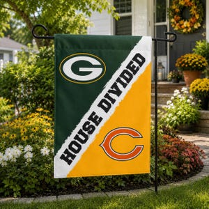 May include: A rectangular garden flag split diagonally between dark green and yellow. The top left features a green and yellow G logo, the bottom right features an orange and navy C logo, and the text HOUSE DIVIDED is printed in black.