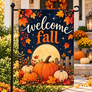 May include: A rectangular garden flag featuring the text welcome fall in white and orange script. The design displays a large full moon, orange and white pumpkins, a wooden fence, and vibrant red and orange autumn maple leaves on a dark blue background.