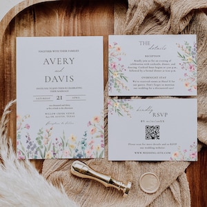 May include: Wedding stationery set with a floral watercolour design. The invitation includes the names "Avery and Davis", date, and venue. The set also includes details and RSVP cards. A gold wax seal and stamp are also present.