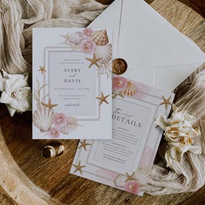 May include: Wedding invitation suite featuring a main invitation and details card. The design includes seashells, starfish, and pink roses, with text that reads "Avery and Davis" and "August 24th at 5 PM". The suite is accented with pearls and a gold wax seal.