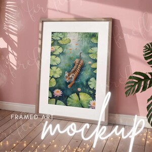 May include: A framed watercolor painting of a tiger swimming in a pond with lily pads. The tiger is orange and black with white stripes. The pond is green and blue with white lily pads.