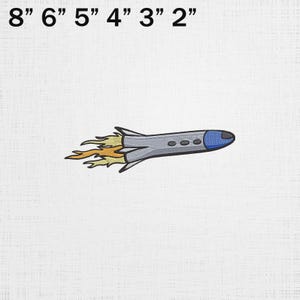 May include: Embroidered patch of a cartoon rocket ship in flight. The rocket is gray with a blue nose and three small portholes. Orange and yellow flames trail from the engine. The patch measures approximately 8 inches long.