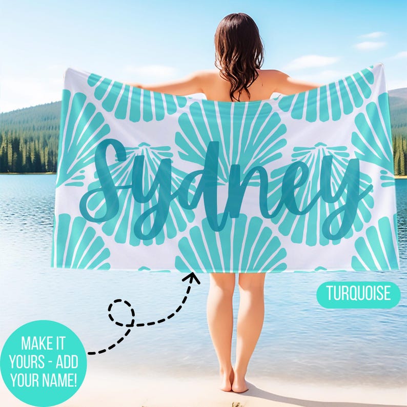 May include: White beach towel with a turquoise seashell pattern and the name "Sydney" in a matching script font. The towel also has the text "Turquoise" and "Make it yours - add your name!"