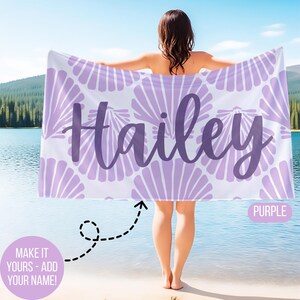 May include: A personalized beach towel with the name "Hailey" in purple script. The towel features a seashell pattern in light purple on a white background. The word "PURPLE" is in a purple box. The text "MAKE IT YOURS - ADD YOUR NAME!" is in a pink circle.