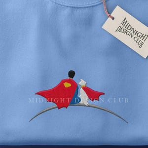 Geborduurde vliegende superheld hondenvrienden | Uniseks sweatshirt van Man of Steel