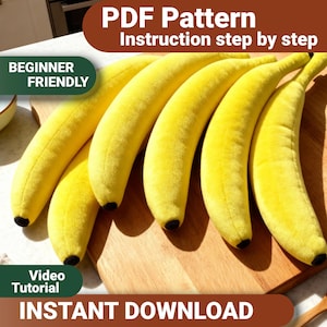 May include: A PDF pattern for a plush banana toy, featuring step-by-step instructions and a video tutorial. The image displays five bright yellow plush bananas with small black tips, arranged on a wooden surface. Text includes PDF Pattern, Instruction step by step, BEGINNER FRIENDLY, Video Tutorial, and INSTANT DOWNLOAD.