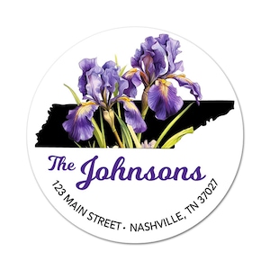 May include: A round sticker with a white background and a black outline of the state of Tennessee.  Two purple iris flowers are in the upper portion of the sticker.  The text "The Johnsons" is in purple cursive font.  The address "123 Main Street, Nashville, TN 37027" is in black text.