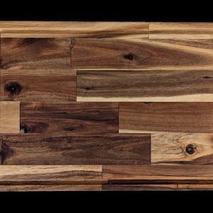 Op de afbeelding: Een rechthoekige houten snijplank met een sapgroef rondom. De plank is gemaakt van verschillende stukken hout, met een mix van lichte en donkere bruintinten. De houtnerf is zichtbaar, wat bijdraagt aan de natuurlijke uitstraling.