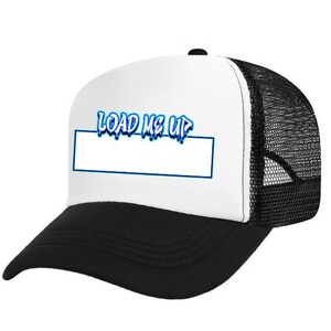 May include: A trucker hat with a white front panel, a black brim, and a black mesh back. The front features the text "LOAD ME UP" in blue, above a white rectangle outlined in blue.