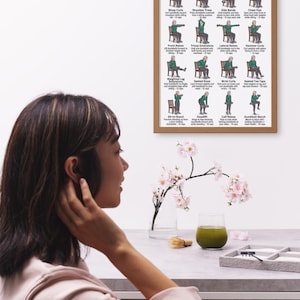 May include: A framed poster titled "Light Dumbbell Exercises for Women 60+" displays illustrations of various exercises. The poster is brown and hangs on a white wall. A woman is seen in the foreground, with a table holding a glass of green liquid and flowers.