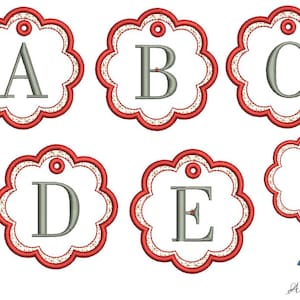 May include: Five red and white scalloped circle tags with letters A, B, C, D, and E in gray. The last tag is blank. The tags have a hole at the top for hanging.