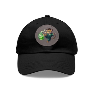 May include: Black baseball cap with a green and brown cartoon jaguar kicking a green drink. The jaguar is wearing a green karate uniform.