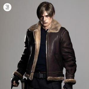 May include: A dark brown leather bomber jacket with a tan faux fur lining, a wide collar, and a front zipper closure. The jacket features visible stitching, ribbed cuffs with fur trim, and is worn over a dark shirt with a black belt and gloves.