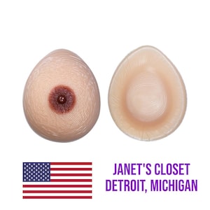 May include: Two silicone breast forms, one with a nipple and areola, the other without. The forms are flesh-toned and have a textured surface.  Janet's Closet Detroit, Michigan.