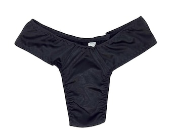 May include: Black, silky, low-rise underwear with a smooth, shiny finish.