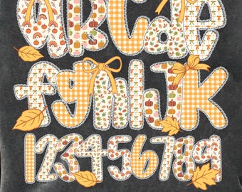 May include: A dark gray graphic featuring the alphabet, numbers, and decorative bows. The letters and numbers are in a patchwork style with fall-themed patterns, including pumpkins and leaves. The text at the bottom reads "Alpha Doodle Bundle- 5 Styles."