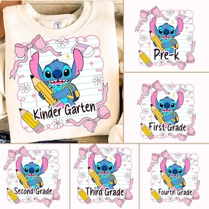 May include: Cream-colored sweatshirt featuring a blue cartoon character holding a yellow pencil and backpack, with the text "Kinder Garten". The design includes pink bows, daisies, and an eraser. Additional designs show the character with "Pre-k", "First Grade", "Second Grade", "Third Grade", and "Fourth Grade" text.