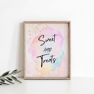 May include: A pink and white watercolor sign with gold glitter. The sign says "Sweet and Treats" in black cursive text.
