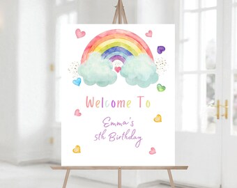 May include: Welcome to Emma's 5th Birthday sign featuring a rainbow, clouds, and hearts. The sign is displayed on an easel.