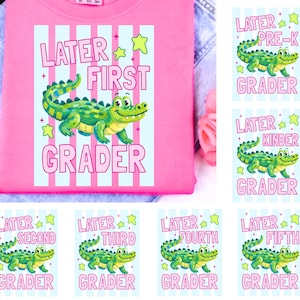 May include: A pink sweatshirt with a graphic featuring a green alligator and the words "LATER FIRST GRADER." Additional cards show the alligator with "PRE-K," "Kinder," "Second," "Third," "Fourth," and "Fifth Grader."